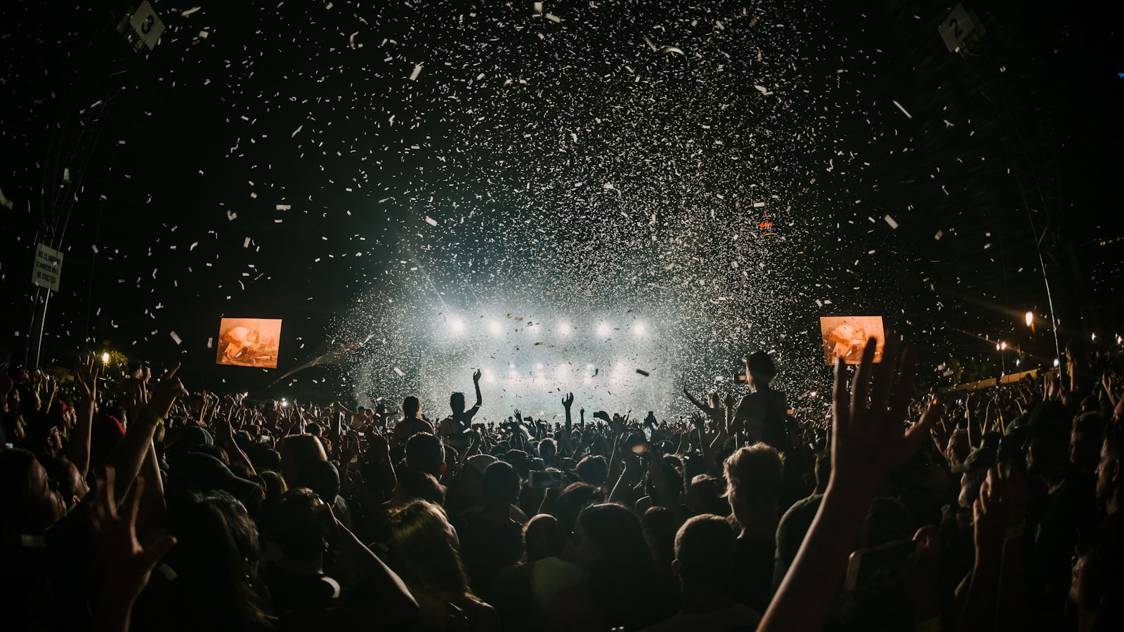 Large crowd gathered on the field of an open-air festival